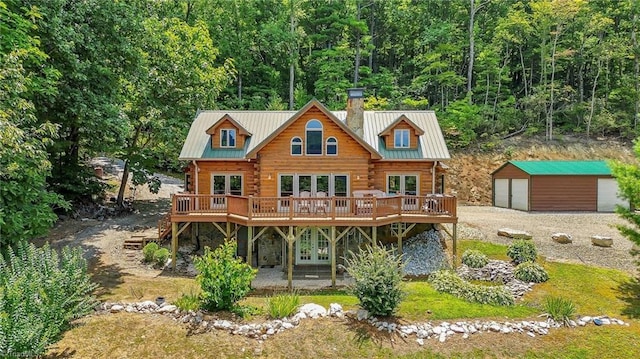 back of property with french doors, metal roof, a chimney, and log siding