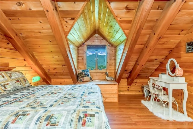 bedroom with vaulted ceiling with beams, wooden ceiling, wooden walls, and light wood-style floors