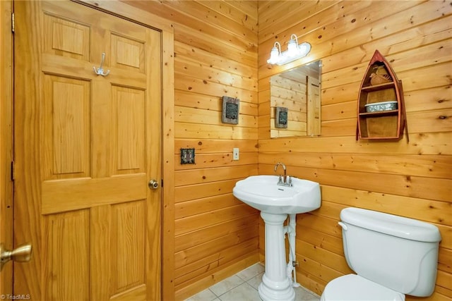 bathroom with toilet and tile patterned floors