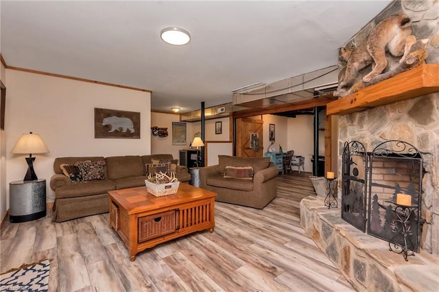 living room featuring light wood finished floors and ornamental molding