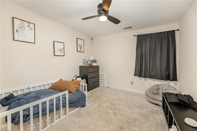 bedroom with visible vents, baseboards, ceiling fan, and carpet flooring