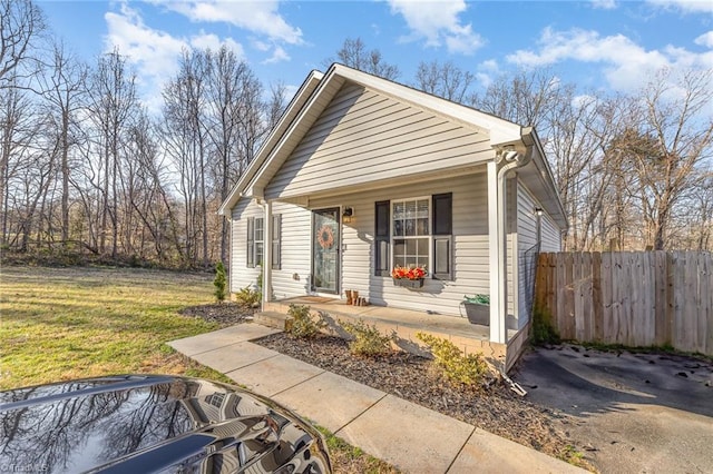 view of front of house with a front lawn and fence