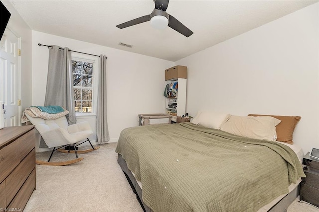 bedroom with light colored carpet, baseboards, and ceiling fan