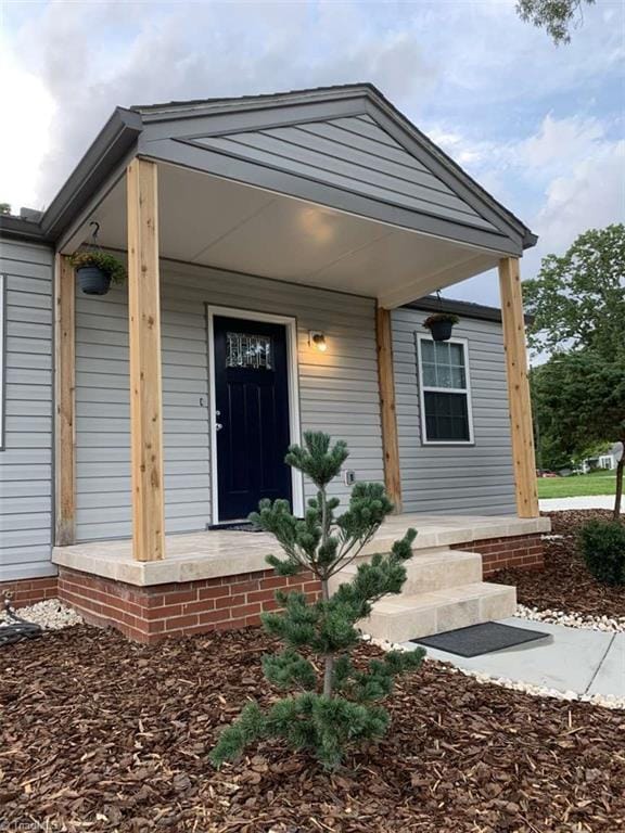 doorway to property featuring a porch