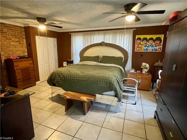 bedroom with ceiling fan, ornamental molding, a textured ceiling, and light tile patterned floors