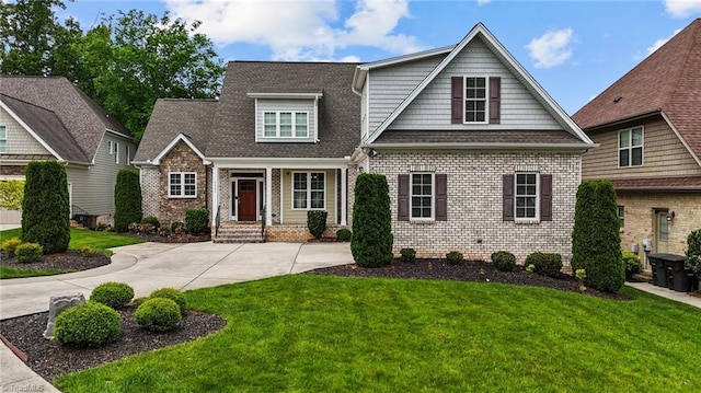 view of front of house with brick siding and a front lawn