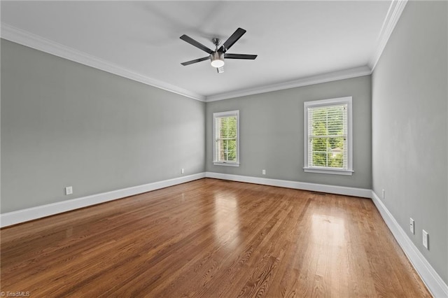 unfurnished room featuring ceiling fan, baseboards, wood finished floors, and ornamental molding