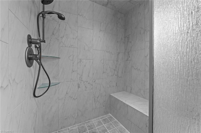 interior details with a tile shower