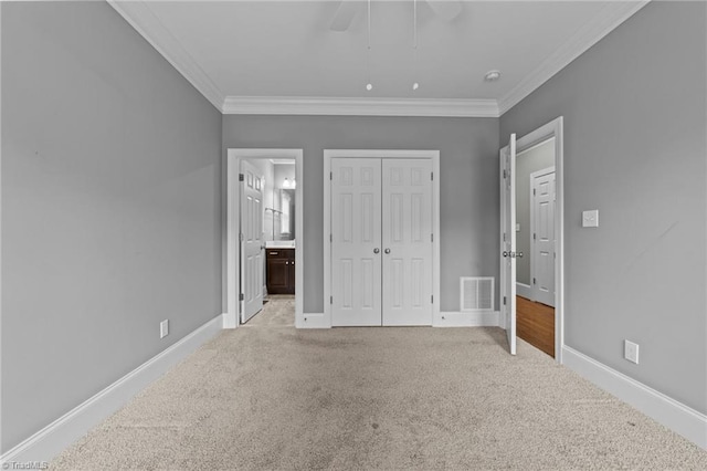 unfurnished bedroom featuring light carpet, baseboards, visible vents, and ornamental molding