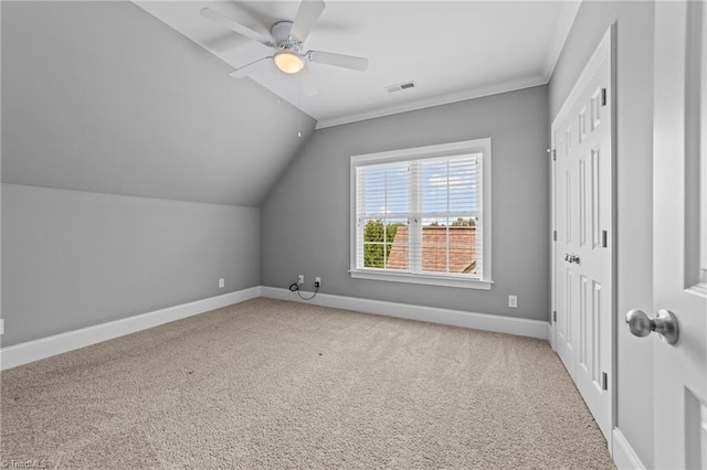 additional living space with ceiling fan, carpet flooring, visible vents, baseboards, and vaulted ceiling