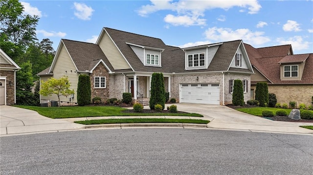 craftsman-style house with a garage, concrete driveway, and brick siding