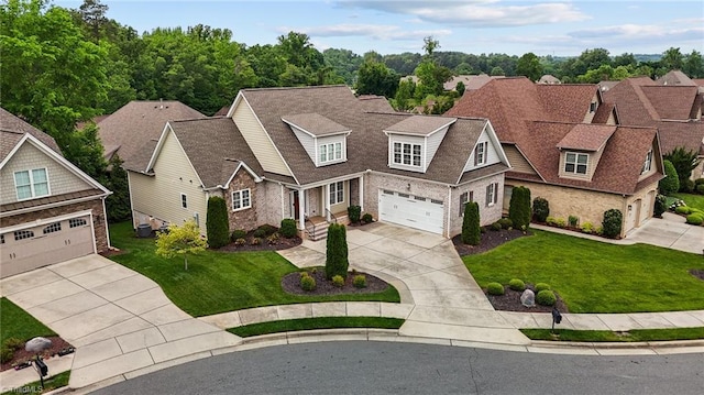 view of front of property with a garage, concrete driveway, roof with shingles, and a front yard