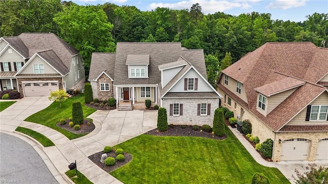 view of front of house featuring driveway, a shingled roof, and a front lawn