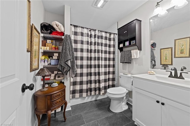 bathroom featuring curtained shower, tile patterned flooring, vanity, and toilet