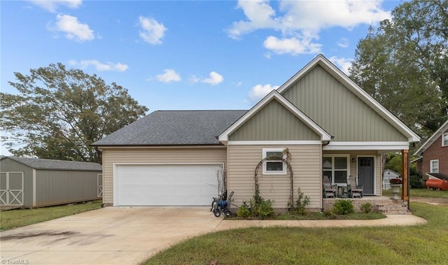 view of front facade featuring a shed, a porch, a garage, and a front yard