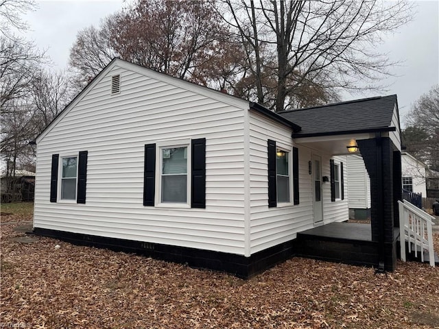 view of side of property featuring a porch