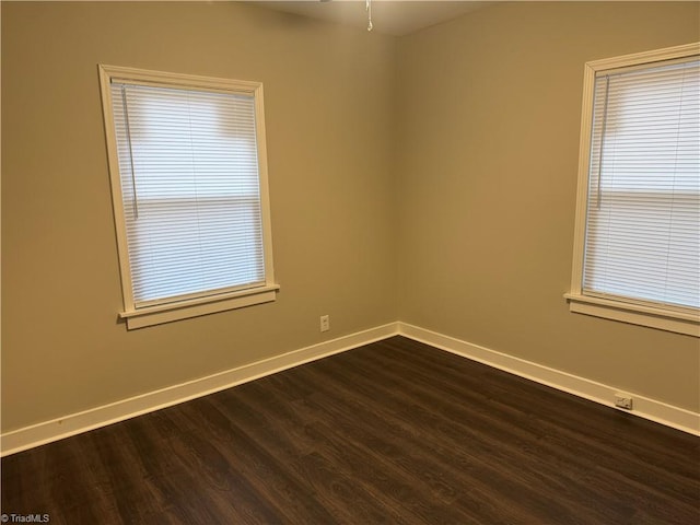 unfurnished room with dark hardwood / wood-style floors