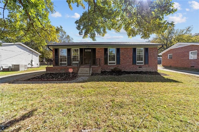 view of front of home featuring a front yard and cooling unit