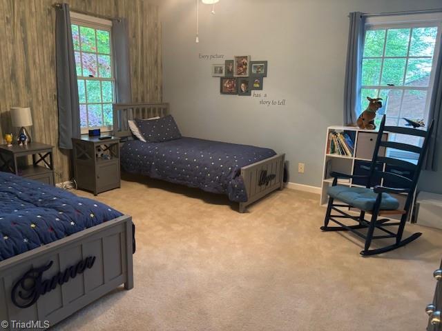bedroom with carpet floors and baseboards