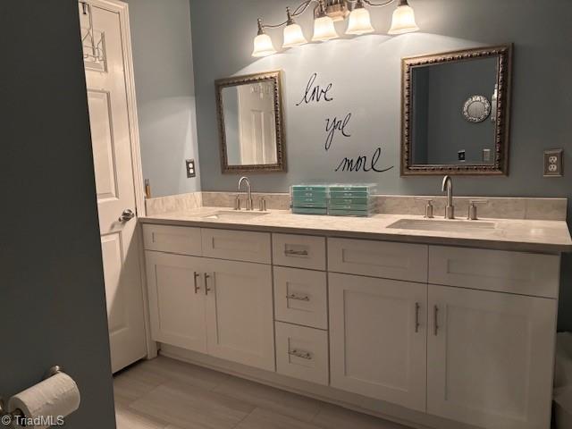 full bath featuring a sink and double vanity