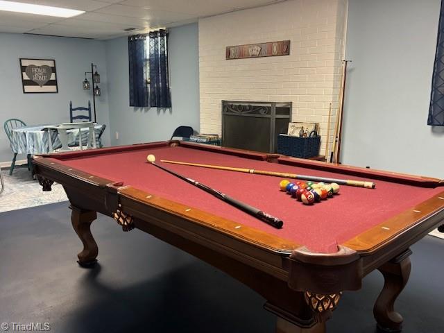 playroom featuring a brick fireplace and pool table