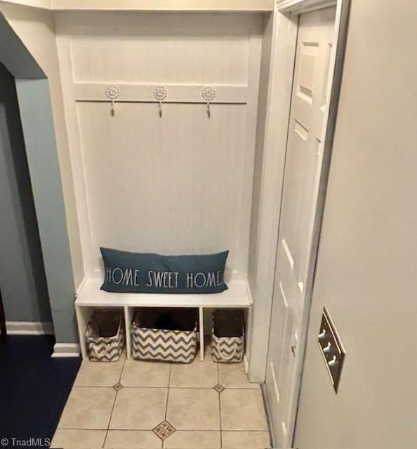 mudroom with tile patterned floors and baseboards
