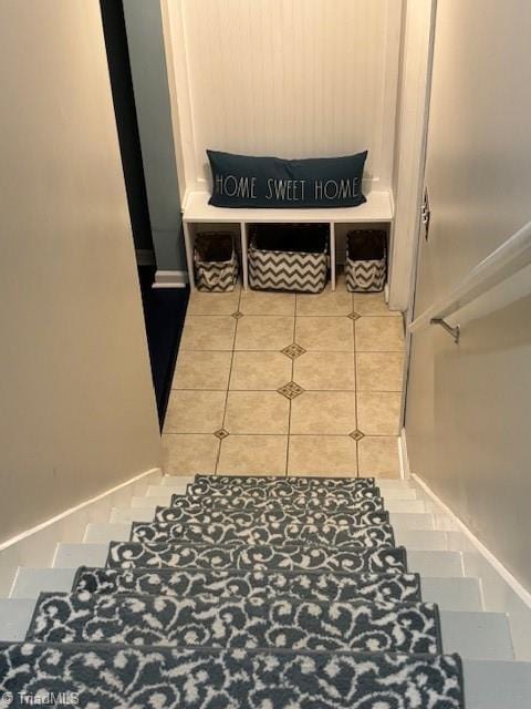 stairs featuring tile patterned flooring