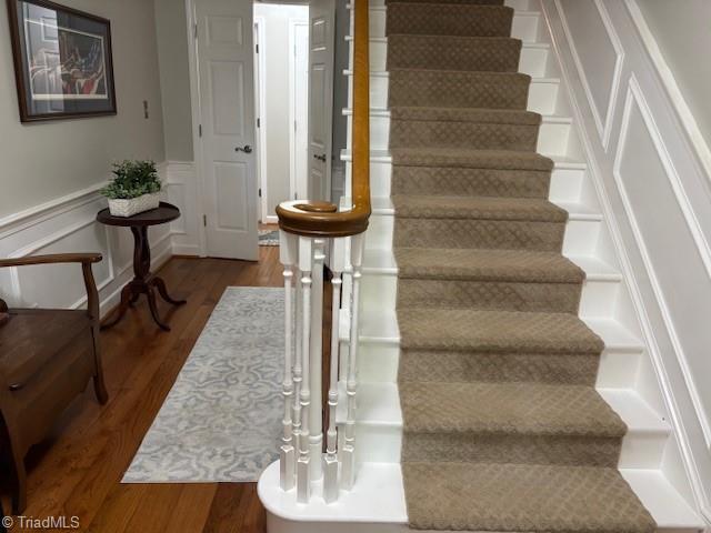 stairway featuring wood finished floors