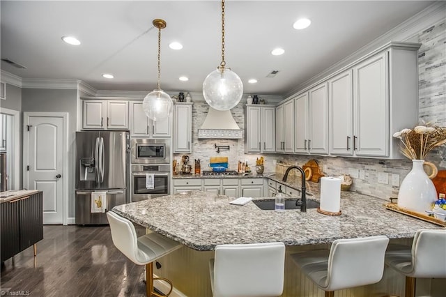 kitchen featuring stainless steel appliances, a sink, visible vents, custom range hood, and crown molding