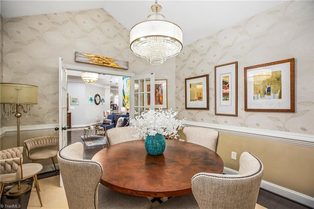 dining area with a notable chandelier, baseboards, wood finished floors, and wallpapered walls