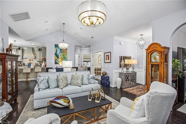 living room with baseboards, visible vents, arched walkways, wood finished floors, and an inviting chandelier