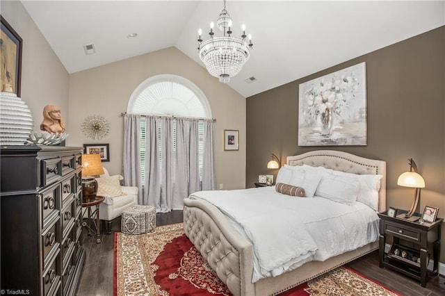 bedroom with vaulted ceiling, wood finished floors, and visible vents