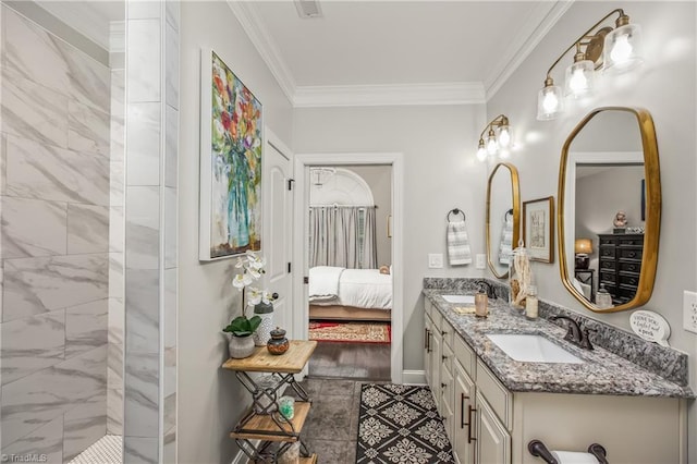 ensuite bathroom featuring ornamental molding, connected bathroom, a sink, and double vanity