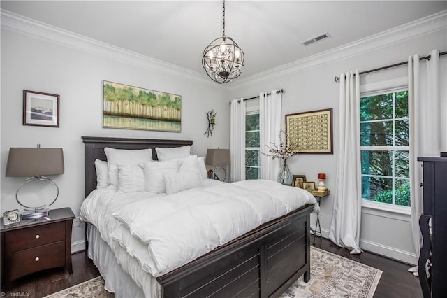 bedroom featuring dark wood-type flooring, multiple windows, and crown molding