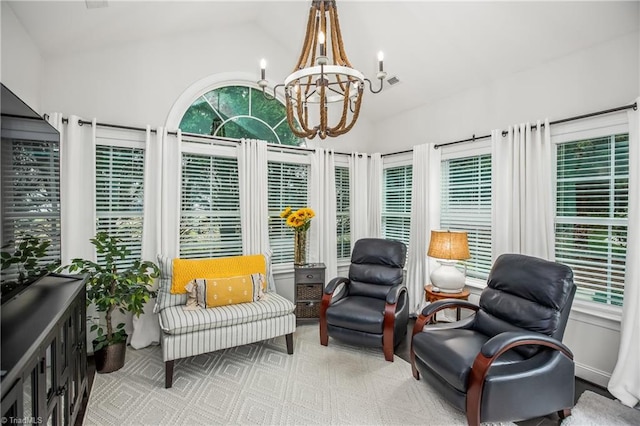 sunroom / solarium with a notable chandelier and vaulted ceiling