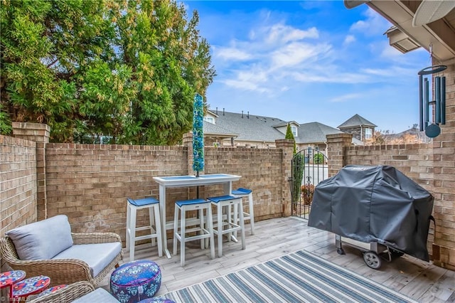 view of patio / terrace with a gate, a grill, outdoor dining area, and fence