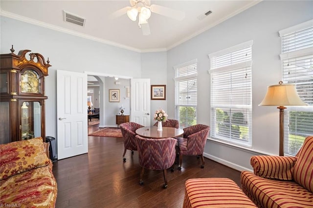 5905 Knowledge Dr, Clemmons, NC 27012 - dining room featuring a ceiling fan, dark wood-style floors, baseboards, crown molding, and arched walkways