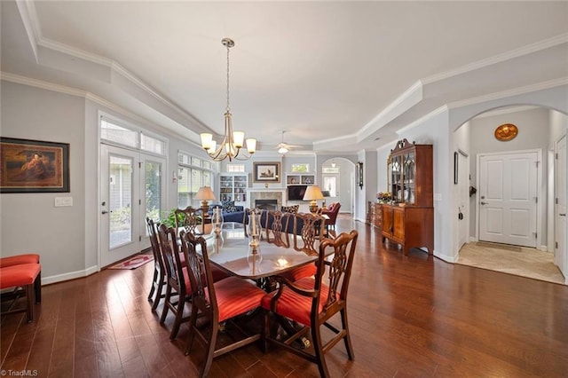 5905 Knowledge Dr, Clemmons, NC 27012 - dining area with arched walkways, dark wood-type flooring, plenty of natural light, baseboards, and crown molding