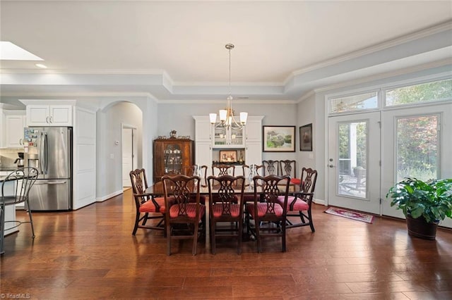 5905 Knowledge Dr, Clemmons, NC 27012 - dining room featuring a chandelier, dark wood-type flooring, ornamental molding, and arched walkways