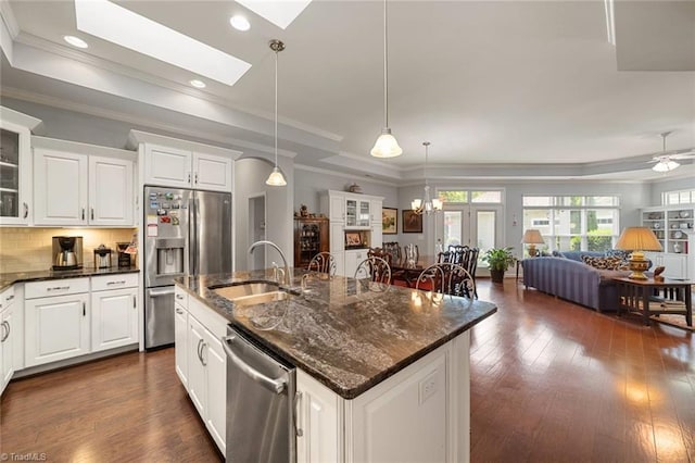 5905 Knowledge Dr, Clemmons, NC 27012 - kitchen with a tray ceiling, stainless steel appliances, a sink, an island with sink, and open floor plan
