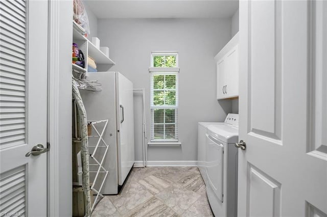 5905 Knowledge Dr, Clemmons, NC 27012 - laundry area with cabinet space, washer and dryer, and baseboards