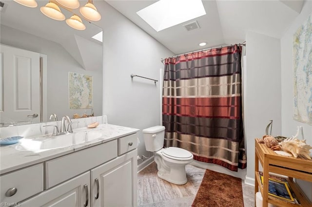 5905 Knowledge Dr, Clemmons, NC 27012 - bathroom featuring a skylight, vaulted ceiling, vanity, toilet, and a shower with curtain