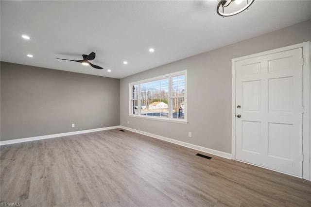 spare room with hardwood / wood-style flooring and ceiling fan