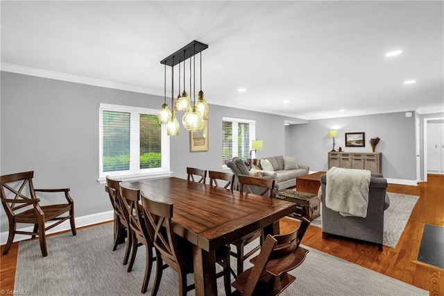 dining area with ornamental molding, wood finished floors, recessed lighting, and baseboards