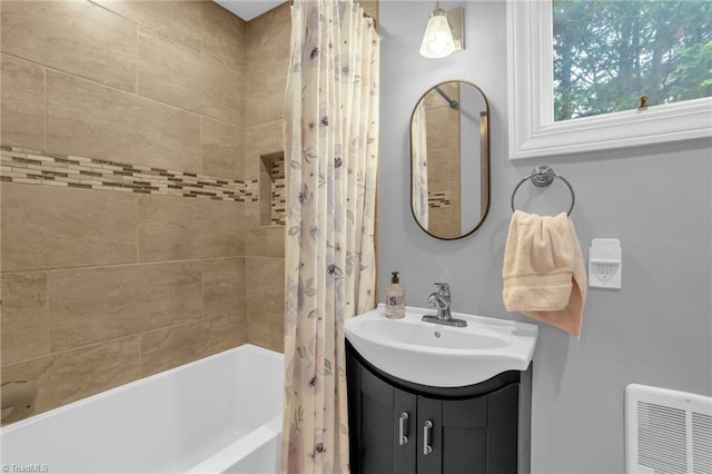 bathroom featuring shower / bath combo with shower curtain and vanity