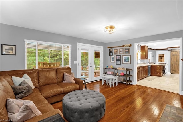 living area featuring french doors and light wood-style floors