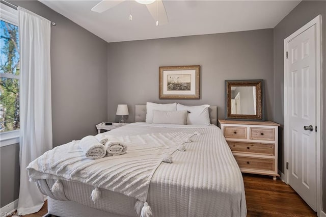 bedroom featuring ceiling fan and dark wood-type flooring