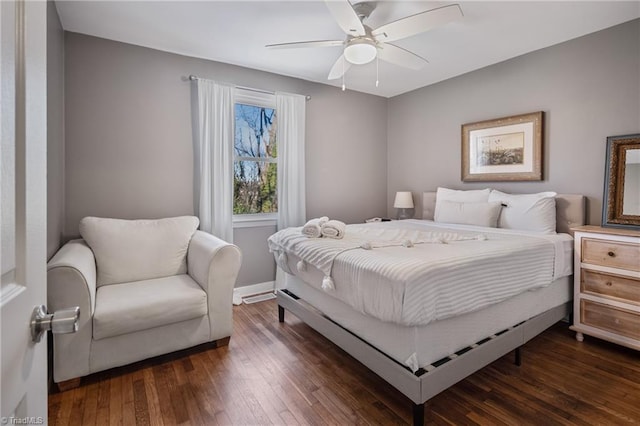 bedroom with ceiling fan and dark hardwood / wood-style flooring