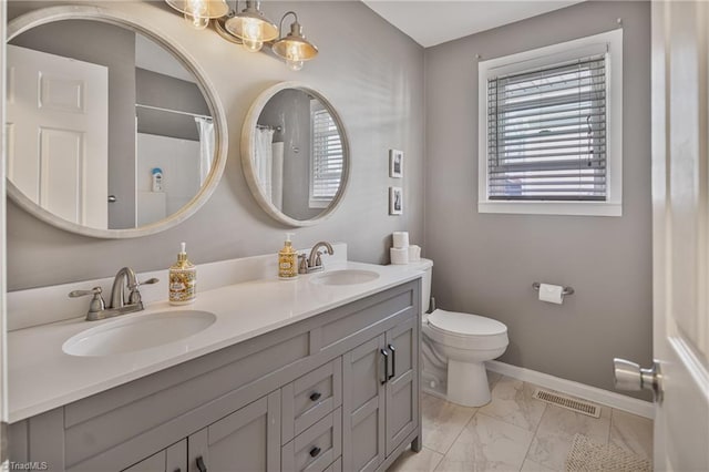 bathroom featuring toilet and vanity