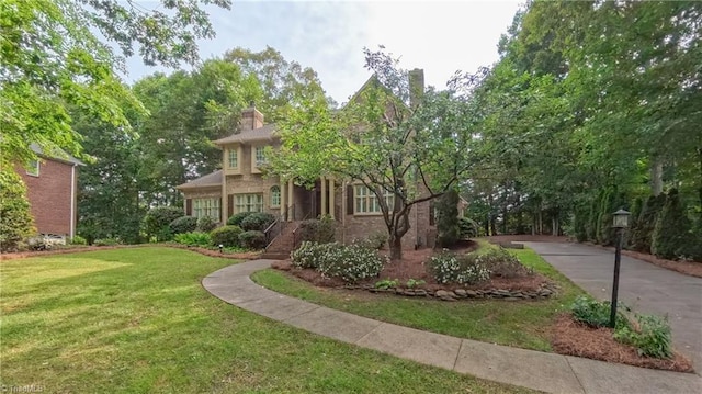 1005 Fallbrook Ln, Lewisville, NC 27023 - view of front of property featuring a front yard and a chimney